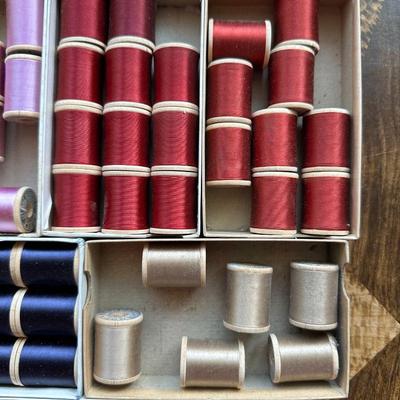 A LARGE ASSORTMENT OF BELDING HEMINWAY THREAD ON WOODEN SPOOLS