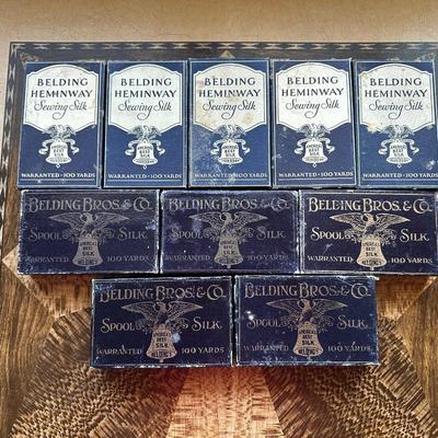 A LARGE ASSORTMENT OF BELDING HEMINWAY THREAD ON WOODEN SPOOLS