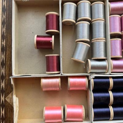 A LARGE ASSORTMENT OF BELDING HEMINWAY THREAD ON WOODEN SPOOLS