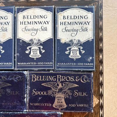 A LARGE ASSORTMENT OF BELDING HEMINWAY THREAD ON WOODEN SPOOLS