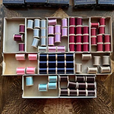 A LARGE ASSORTMENT OF BELDING HEMINWAY THREAD ON WOODEN SPOOLS