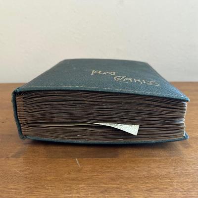 A POSTCARD BOOK FULL OF OLD POSTCARDS