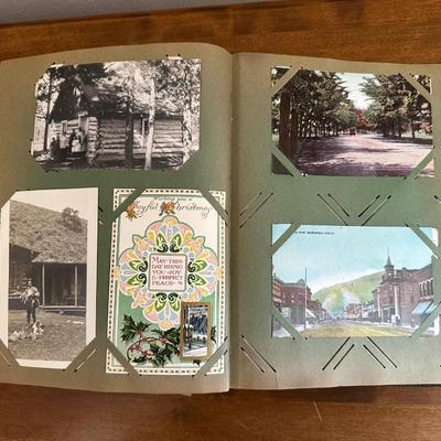 A POSTCARD BOOK FULL OF OLD POSTCARDS