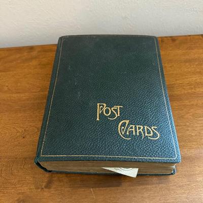 A POSTCARD BOOK FULL OF OLD POSTCARDS
