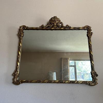 WALL MIRROR WITH AN ORNATE FRAME