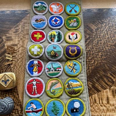 VINTAGE BOY SCOUTS SASH WITH MERIT BADGES, NECKERCHIEF HOLDERS AND WEBELOS TRICOLOR RIBBON WITH PINS