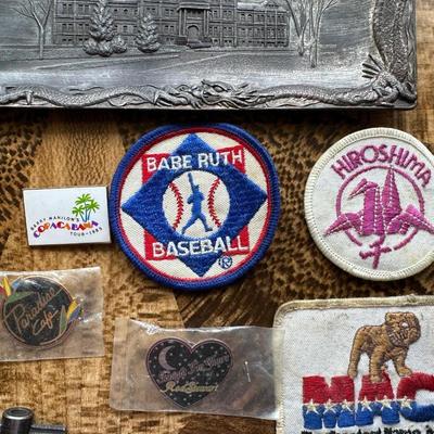 NICE ASSORTMENT OF PATCHES, PINS, VINTAGE MAGNIFYING GLASS LOUPE, METAL COINS AND MORE