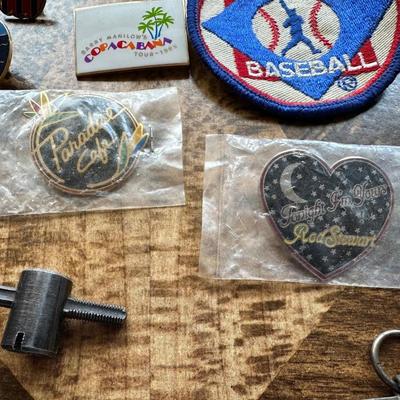 NICE ASSORTMENT OF PATCHES, PINS, VINTAGE MAGNIFYING GLASS LOUPE, METAL COINS AND MORE