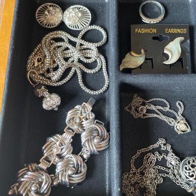 Silver tone jewelry in plastic organizer