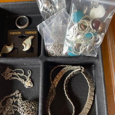 Silver tone jewelry in plastic organizer