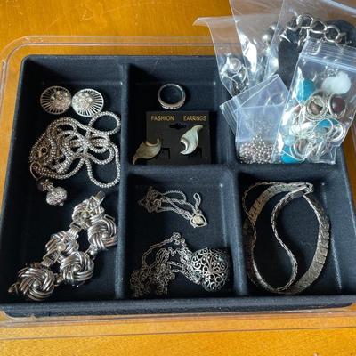 Silver tone jewelry in plastic organizer