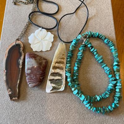 Wood, shell necklaces and a polished rock