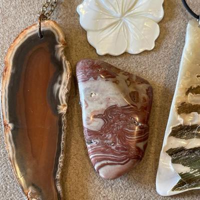 Wood, shell necklaces and a polished rock