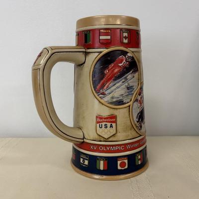LOT 118: Set of Centennial Celebration The Olympiad Greatest Moments Poster Collection & Calgary 1988 Winter Olympic Winter Games Stein