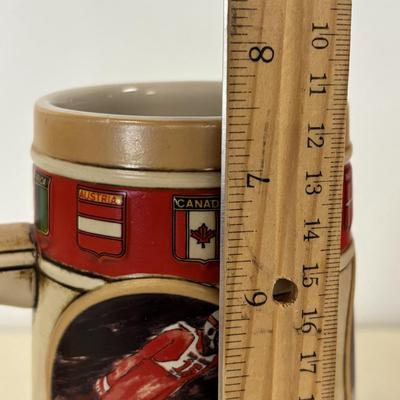 LOT 118: Set of Centennial Celebration The Olympiad Greatest Moments Poster Collection & Calgary 1988 Winter Olympic Winter Games Stein