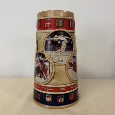 LOT 118: Set of Centennial Celebration The Olympiad Greatest Moments Poster Collection & Calgary 1988 Winter Olympic Winter Games Stein
