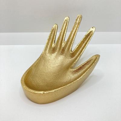 LOT 120: Gold Tone Hand Jewelry / Ring Holder with Collection of Earrings - Kenneth Cole, Baublebar and More