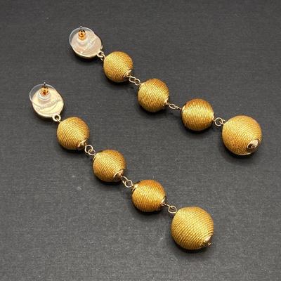 LOT 120: Gold Tone Hand Jewelry / Ring Holder with Collection of Earrings - Kenneth Cole, Baublebar and More