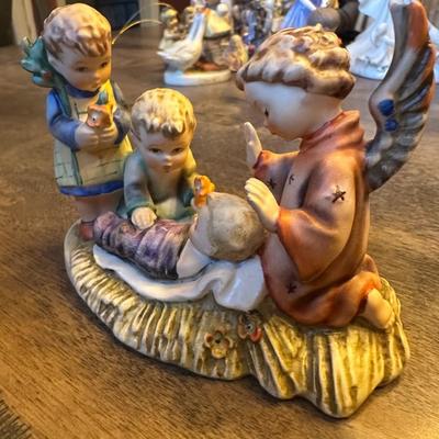 Sale Photo Thumbnail #525: ANGLE AND BOY LOOKING OVER BABY FIGURINE