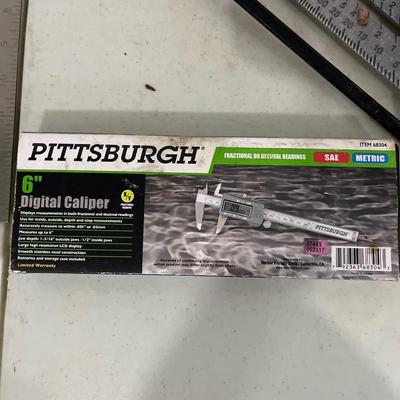 Square, triangle, chalk, reel, wrench holders, and caliper