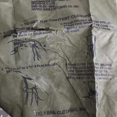 Military issued rain suit and waterproof clothing bag