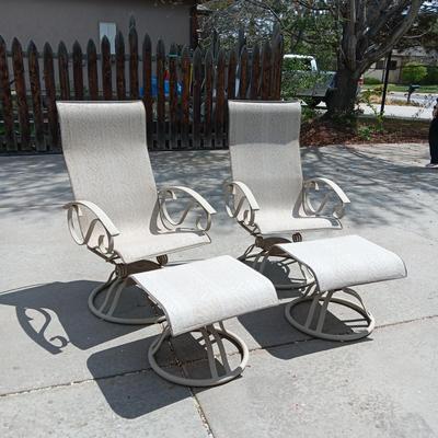 2 VERY NICE ROCKING PATIO CHAIRS WITH OTTOMANS AND A SIDE TABLE