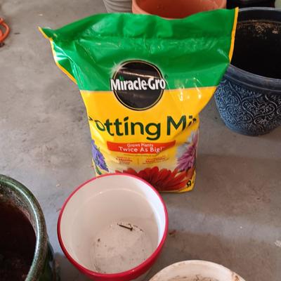 CERAMIC AND CLAY FLOWER POTS PLUS A NEW BAG OF POTTING SOIL