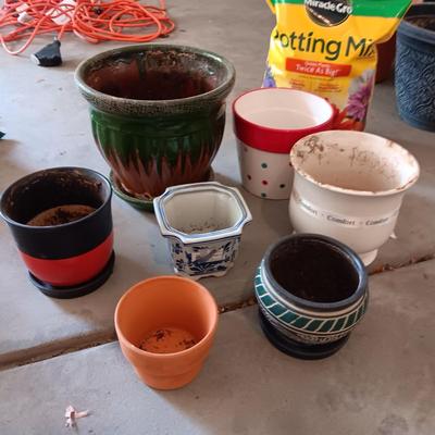 CERAMIC AND CLAY FLOWER POTS PLUS A NEW BAG OF POTTING SOIL