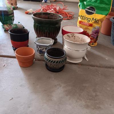 CERAMIC AND CLAY FLOWER POTS PLUS A NEW BAG OF POTTING SOIL