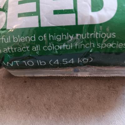 WOODEN FAIRLY LARGE BIRD FEEDER AND THISTLE BIRD SEED