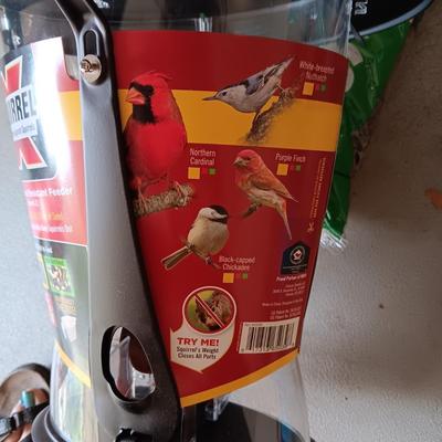 NEW SQUIRREL RESISTANT BIRD FEEDER AND A BAG OF THISTLE BIRD SEED