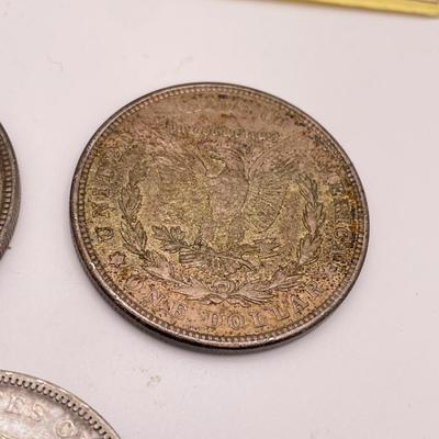 Four Morgan Dollars, a Cincinnati Half Dollar & Capped Bust Half Dime (ST-SS)