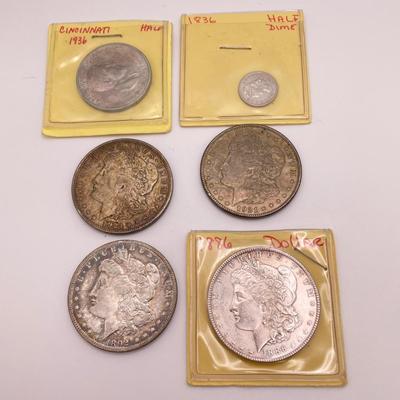 Four Morgan Dollars, a Cincinnati Half Dollar & Capped Bust Half Dime (ST-SS)