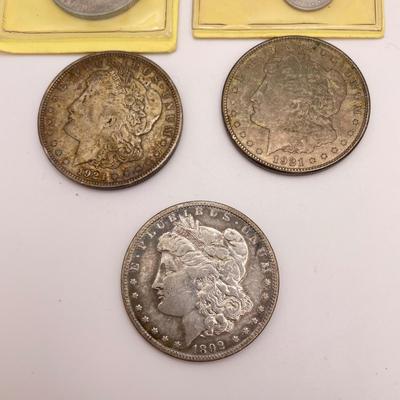 Four Morgan Dollars, a Cincinnati Half Dollar & Capped Bust Half Dime (ST-SS)