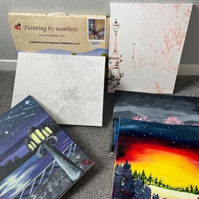Paint by numbers kit, one canvas, and four painted canvases