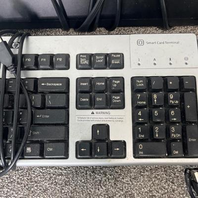HP Envy laptop, keyboard and mouse, power strips
