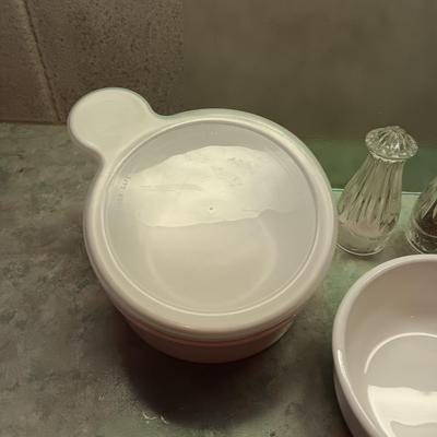 5 CORNING WARE DISHES WITH HANDLES, GLASS SHAKERS, RAMEKINS AND A GLASS CUTTING BOARD