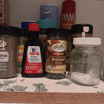 A VARIETY OF SPICES AND A SET OF SHAKERS