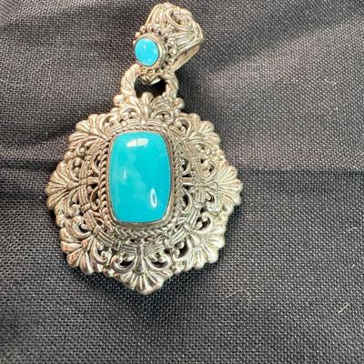 Sarda sterling silver floral pendant with carved unakite.