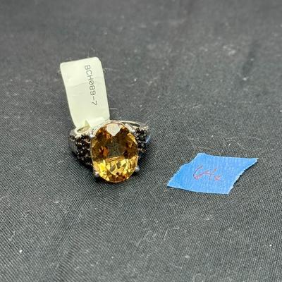 sterling silver ring featuring a large, oval-cut citrine gemstone