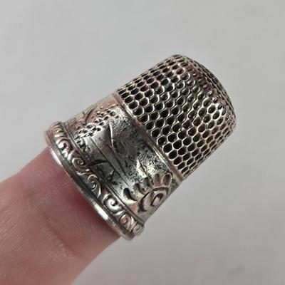 Sale Photo Thumbnail #36: This auction lot is for a Vintage Sterling Silver Thimble.  This is a very nice ornate Sterling Silver Thimble. It weighs about 6 grams  It is monogrammed with what looks like a C or G - near the worn wording of Sterling 9.  It also has a fancy S in a shi