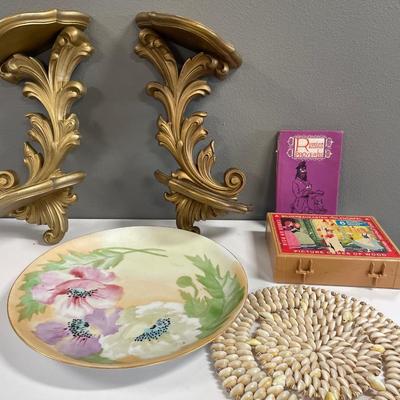 Gold wall shelves with puzzle and books