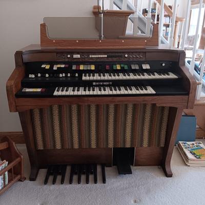 HAMMOND ORGAN WITH ALL THE BELLS AND WHISTLES, PIANO LIGHT AND A BENCH PLUS A LOT OF SHEET MUSIC