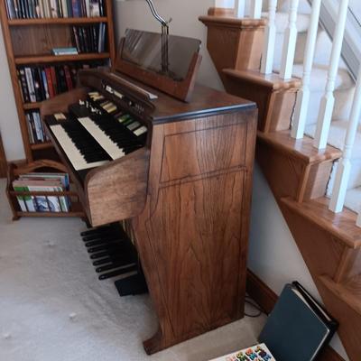 HAMMOND ORGAN WITH ALL THE BELLS AND WHISTLES, PIANO LIGHT AND A BENCH PLUS A LOT OF SHEET MUSIC
