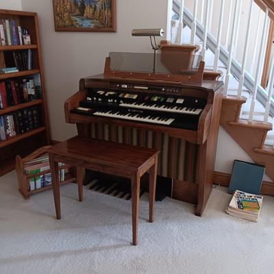 HAMMOND ORGAN WITH ALL THE BELLS AND WHISTLES, PIANO LIGHT AND A BENCH PLUS A LOT OF SHEET MUSIC