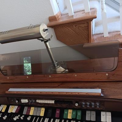 HAMMOND ORGAN WITH ALL THE BELLS AND WHISTLES, PIANO LIGHT AND A BENCH PLUS A LOT OF SHEET MUSIC