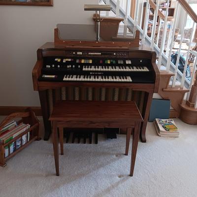 HAMMOND ORGAN WITH ALL THE BELLS AND WHISTLES, PIANO LIGHT AND A BENCH PLUS A LOT OF SHEET MUSIC