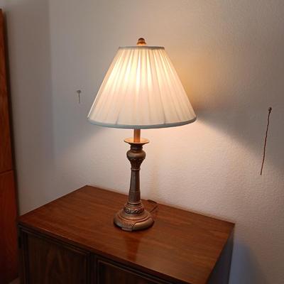 2 DOOR CABINET FILLED WITH PLACEMATS AND A LAMP WITH A DIMMER SWITCH