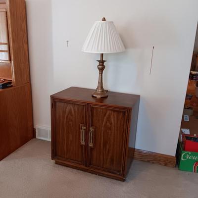 2 DOOR CABINET FILLED WITH PLACEMATS AND A LAMP WITH A DIMMER SWITCH