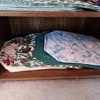 2 DOOR CABINET FILLED WITH PLACEMATS AND A LAMP WITH A DIMMER SWITCH